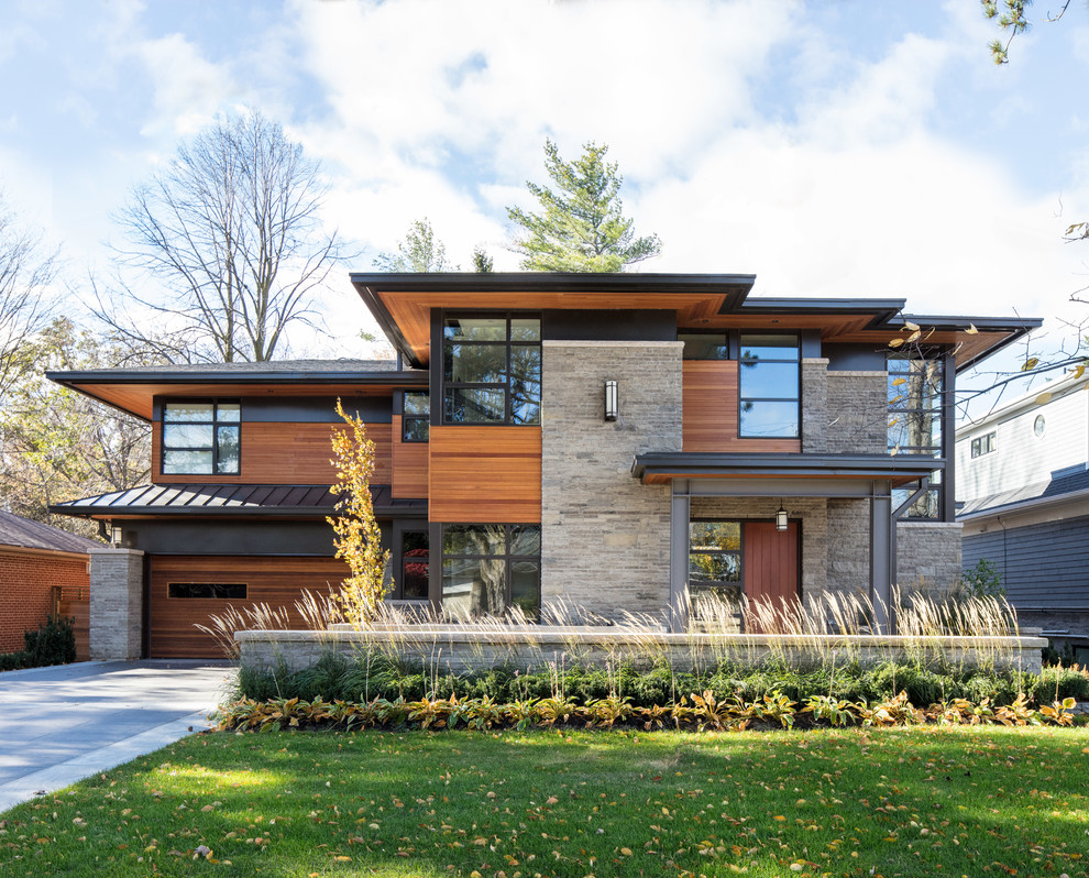 Inspiration for a contemporary exterior in Toronto with mixed siding.