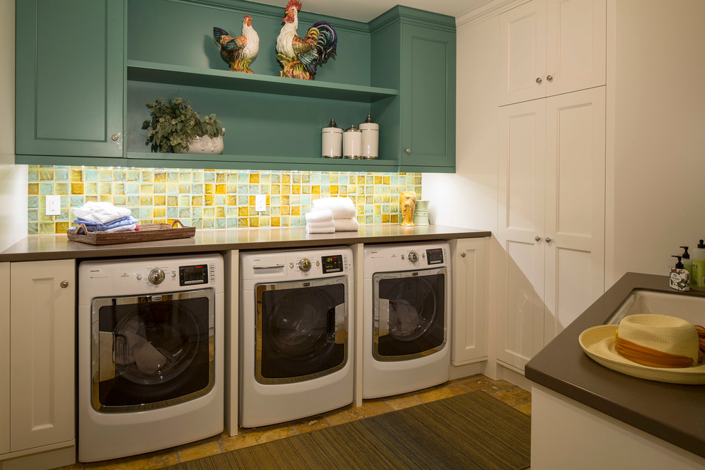 This is an example of a traditional laundry room in Minneapolis with white cabinets.