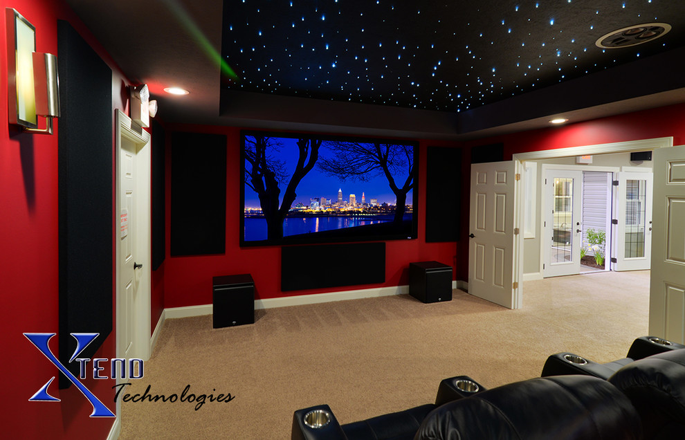 Mid-sized modern enclosed home theatre in Cleveland with red walls, carpet and a projector screen.