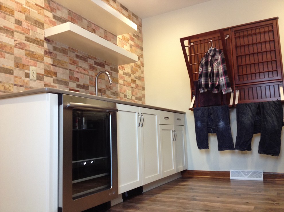 Mid-sized transitional l-shaped utility room photo with an undermount sink, shaker cabinets, white cabinets, quartz countertops, beige walls and a side-by-side washer/dryer