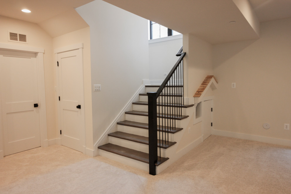 Design ideas for a mid-sized contemporary wood u-shaped staircase in DC Metro with wood risers and metal railing.