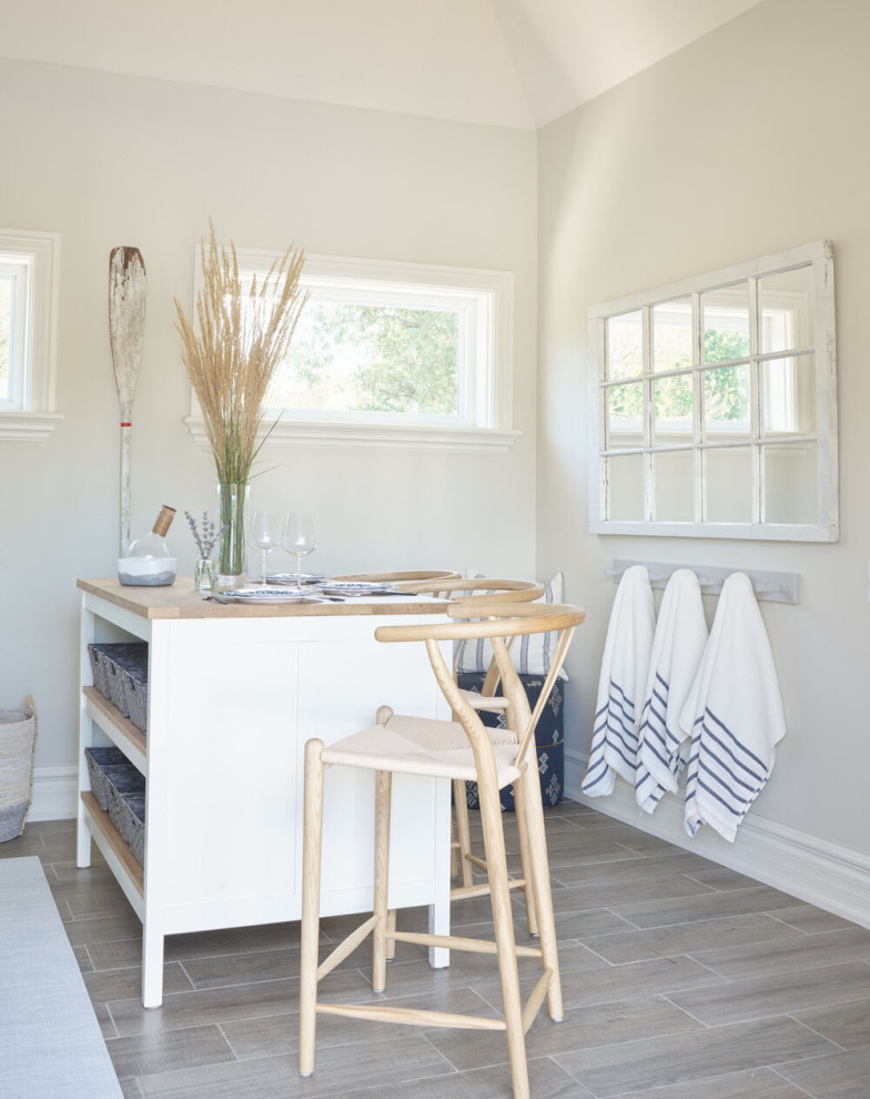 Eat-in kitchen - mid-sized transitional u-shaped vinyl floor and brown floor eat-in kitchen idea with an undermount sink, shaker cabinets, white cabinets, marble countertops, white backsplash, subway tile backsplash, an island and gray countertops