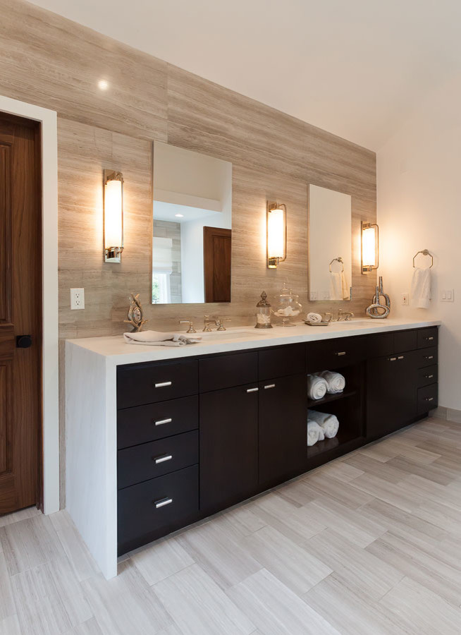 Expansive contemporary master bathroom in Los Angeles with flat-panel cabinets, dark wood cabinets, a freestanding tub, a corner shower, gray tile, mosaic tile, multi-coloured walls, light hardwood floors, a trough sink, engineered quartz benchtops, brown floor and a hinged shower door.