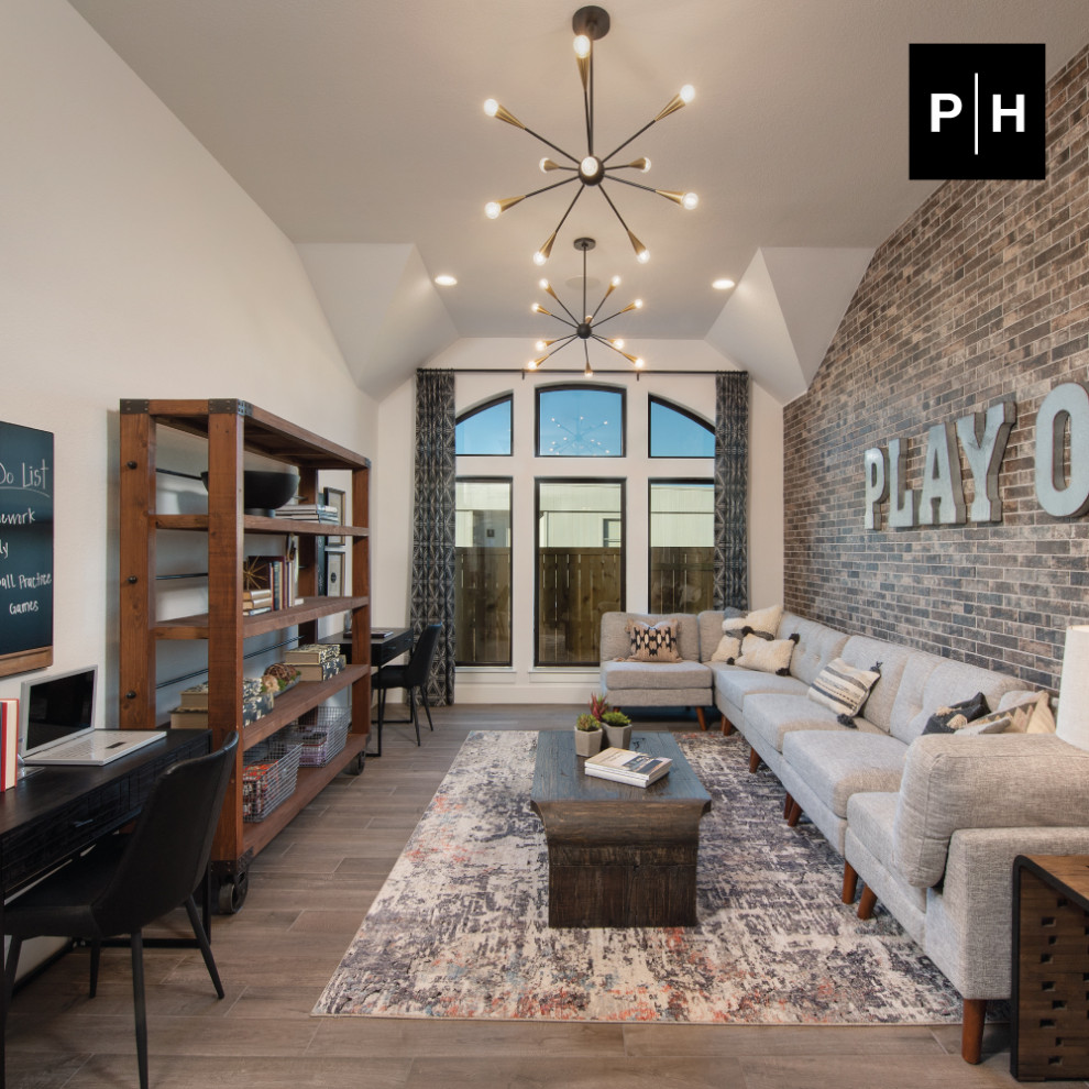 Photo of an enclosed family room in Austin with a game room, white walls and brick walls.