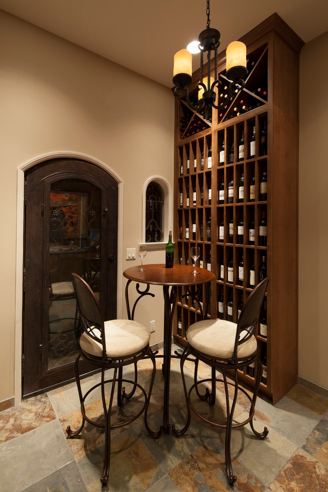 Photo of a mid-sized traditional wine cellar in Los Angeles with slate floors and diamond bins.