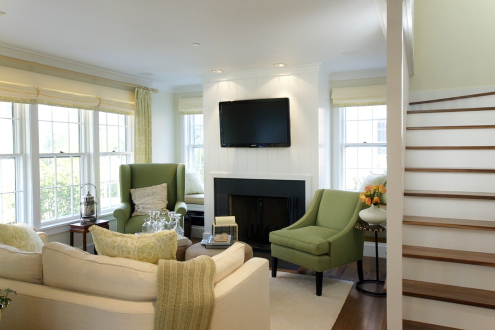 This is an example of a mid-sized transitional open concept living room in Boston with yellow walls, light hardwood floors, a standard fireplace, a stone fireplace surround and a wall-mounted tv.