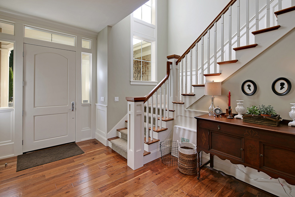 Inspiration for a large transitional foyer in Seattle with beige walls, medium hardwood floors, a single front door and a white front door.