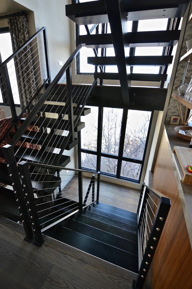 This is an example of a transitional wood floating staircase in Salt Lake City with open risers and mixed railing.