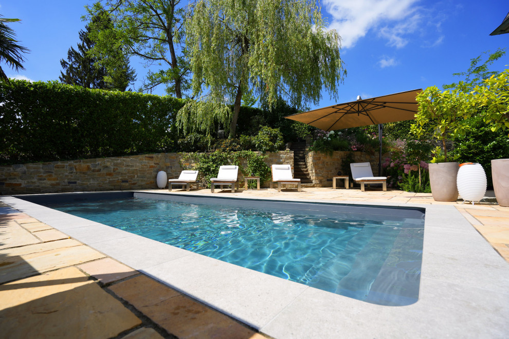 Inspiration for a contemporary side yard stone and rectangular lap pool remodel in Cologne