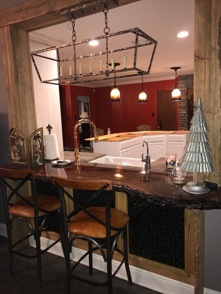Large mountain style enclosed kitchen photo with a farmhouse sink, raised-panel cabinets, white cabinets, wood countertops and an island