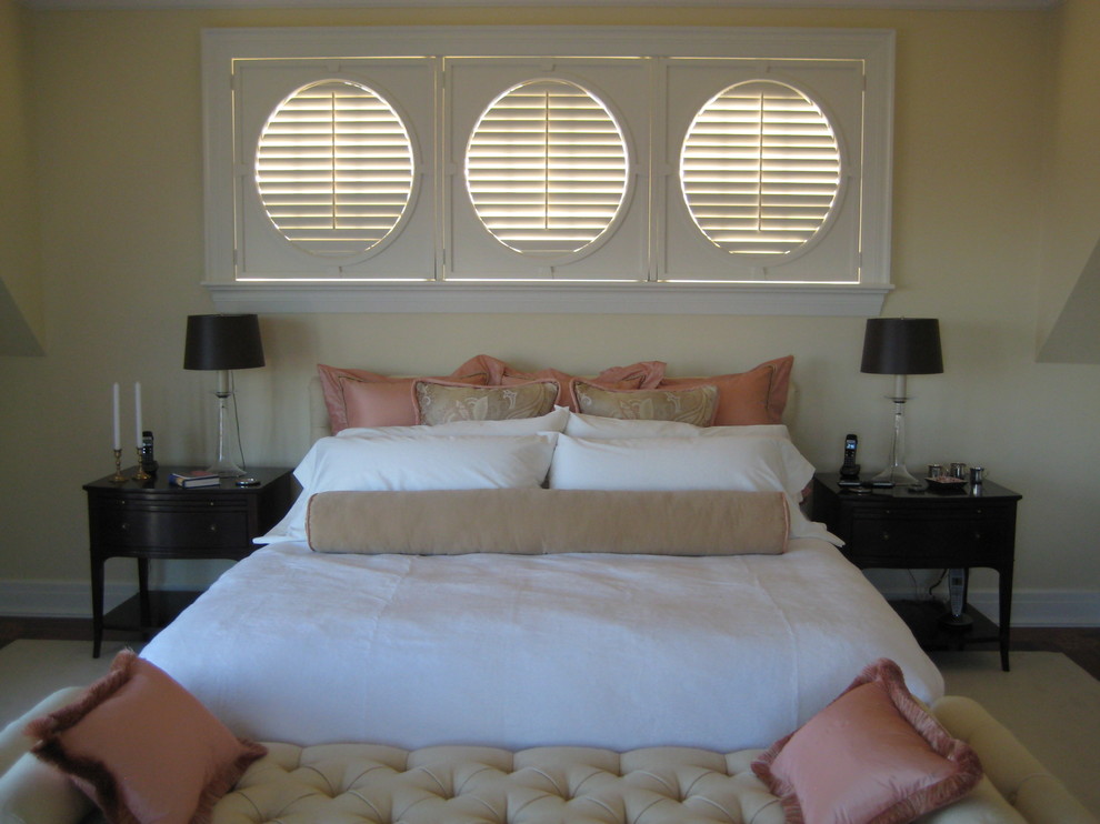 Inspiration for a transitional master bedroom in Portland Maine with beige walls and medium hardwood floors.