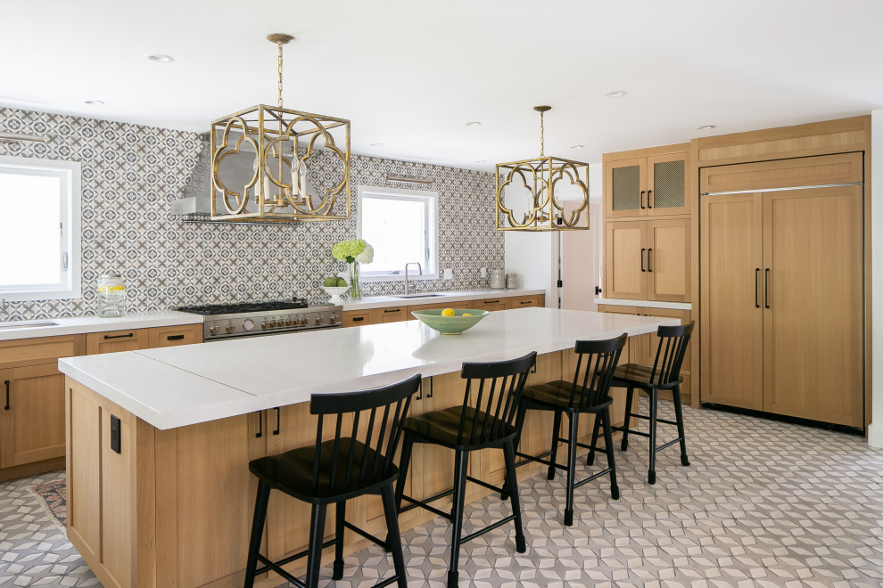Example of a transitional u-shaped multicolored floor open concept kitchen design in Los Angeles with an undermount sink, shaker cabinets, medium tone wood cabinets, quartz countertops, multicolored backsplash, paneled appliances, an island and white countertops
