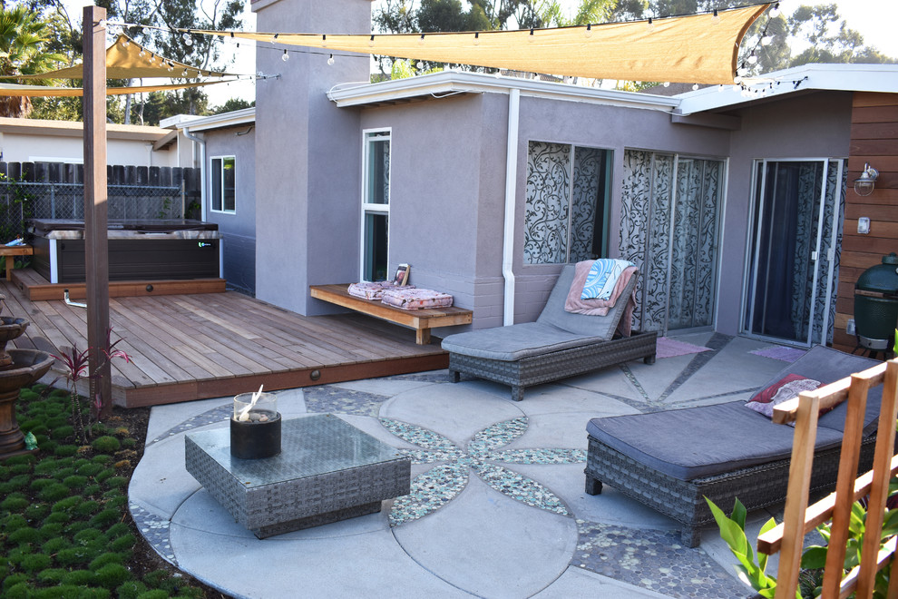 Photo of a mid-sized contemporary backyard full sun garden in San Diego with decking.