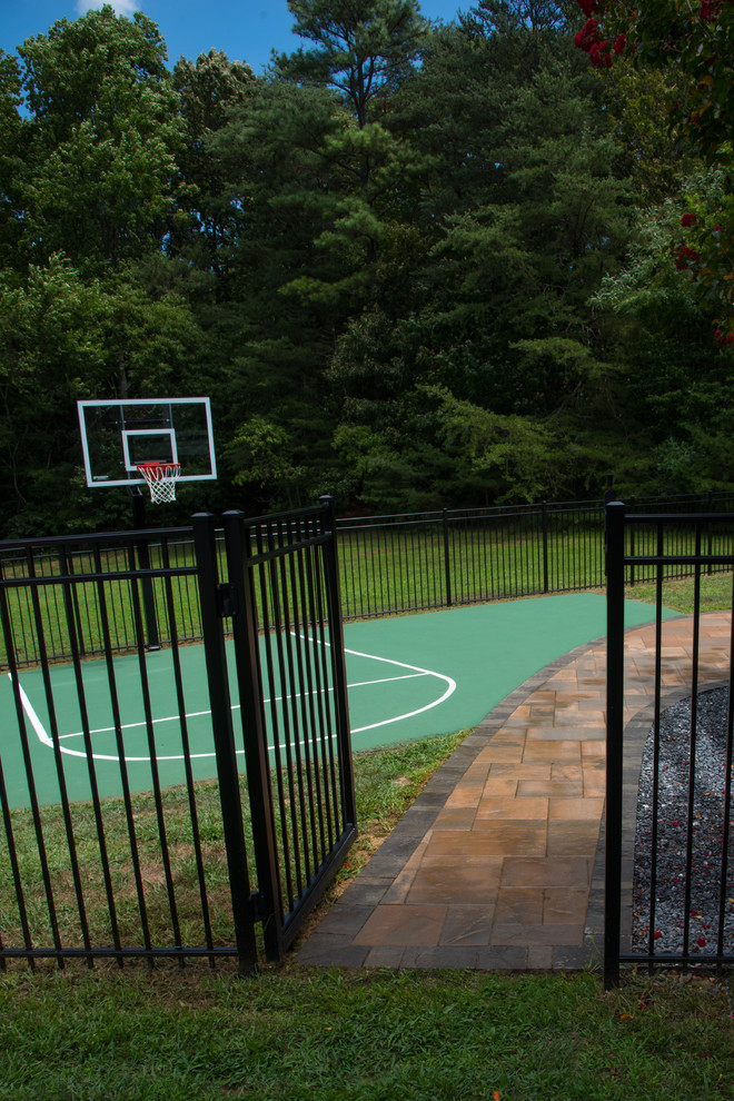 Design ideas for a backyard outdoor sport court in DC Metro with concrete pavers.
