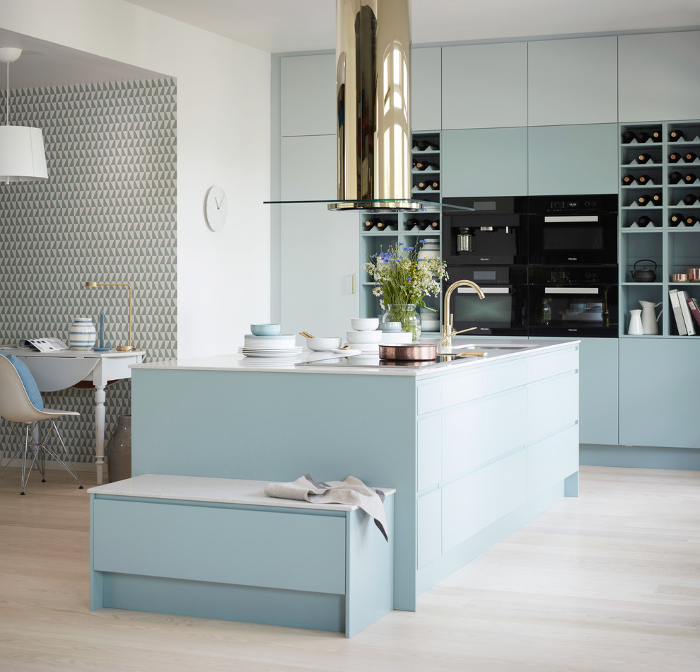 Inspiration for a large scandinavian single-wall kitchen in Gothenburg with flat-panel cabinets, blue cabinets, black appliances, light hardwood floors, no island and quartz benchtops.