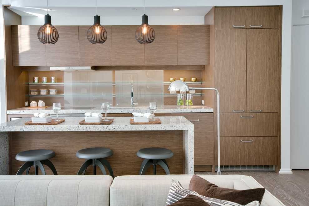 Inspiration for a mid-sized contemporary galley open plan kitchen in Toronto with an undermount sink, flat-panel cabinets, quartz benchtops, with island, dark wood cabinets, brown splashback, panelled appliances, medium hardwood floors and glass sheet splashback.