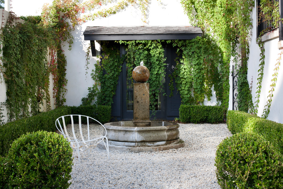 Inspiration for a mediterranean courtyard garden in Little Rock with a water feature.