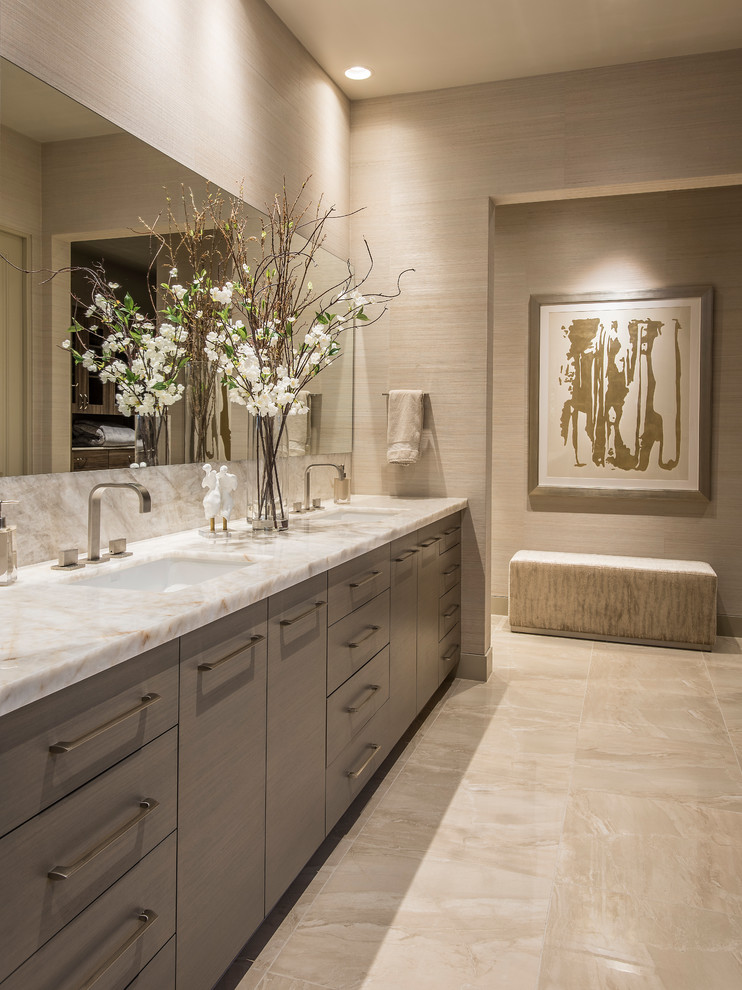Inspiration for a large contemporary master bathroom in Phoenix with flat-panel cabinets, grey cabinets, a freestanding tub, a corner shower, a one-piece toilet, beige tile, porcelain tile, beige walls, porcelain floors, an undermount sink, quartzite benchtops, beige floor, a hinged shower door and white benchtops.