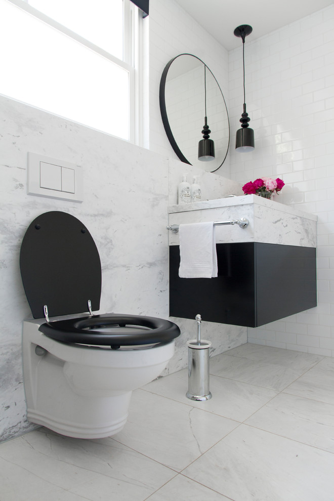 Photo of a large traditional master bathroom in Sydney with furniture-like cabinets, black cabinets, a claw-foot tub, white tile, porcelain tile, white walls, marble floors, an undermount sink, marble benchtops and a two-piece toilet.