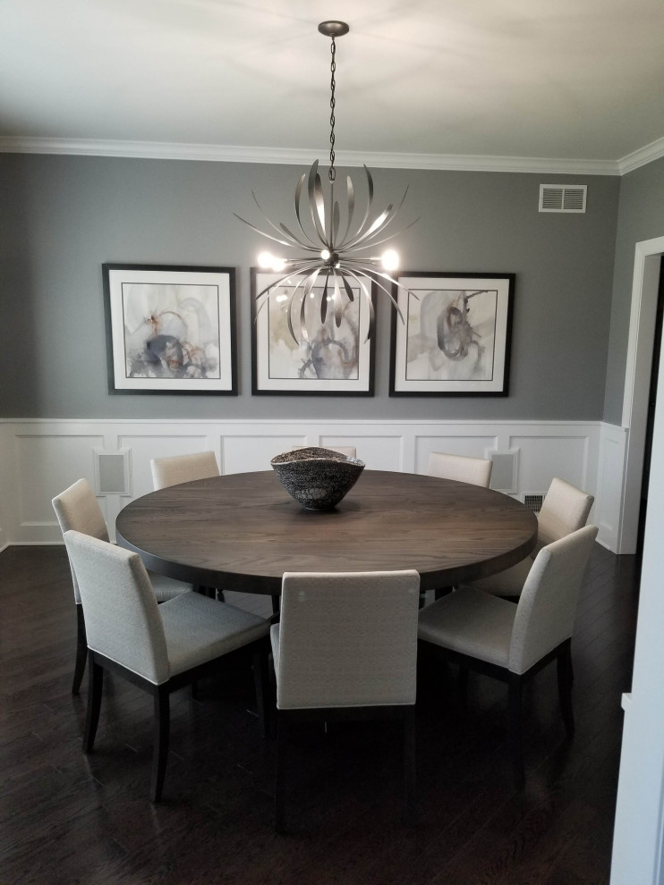 This is an example of a medium sized contemporary enclosed dining room in Chicago with grey walls, dark hardwood flooring, brown floors and wainscoting.