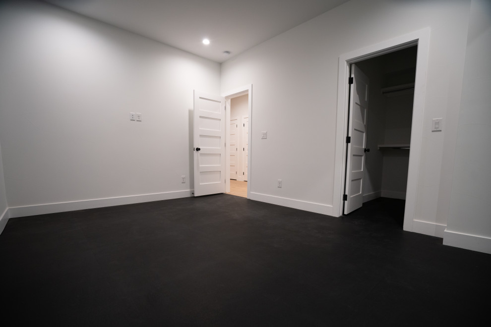 Photo of a mid-sized modern multipurpose gym in Denver with white walls and black floor.