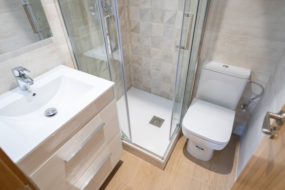 Inspiration for a mid-sized contemporary master bathroom in Barcelona with light wood cabinets, a corner shower, a one-piece toilet, beige tile, ceramic tile, ceramic floors, a trough sink, brown floor, a sliding shower screen, white benchtops, an enclosed toilet, a single vanity and a floating vanity.