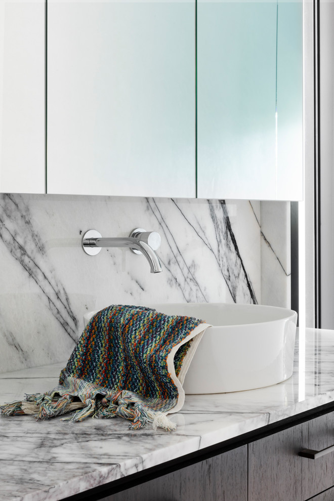 Inspiration for a mid-sized contemporary 3/4 bathroom in Melbourne with flat-panel cabinets, dark wood cabinets, an open shower, a wall-mount toilet, white tile, limestone, white walls, limestone floors, a vessel sink, marble benchtops, beige floor, an open shower and multi-coloured benchtops.
