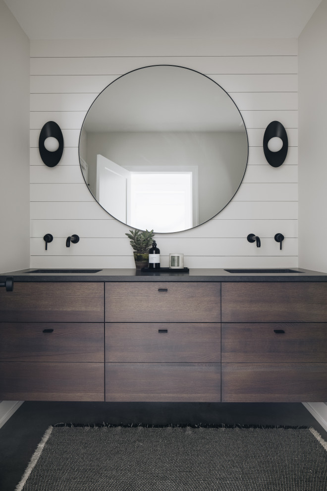 Bathroom - Beach style concrete floor, gray floor, double-sink and shiplap wall bathroom photo in Grand Rapids with white walls, an undermount sink, quartz countertops, black countertops, a floating vanity, dark wood cabinets and flat-panel cabinets