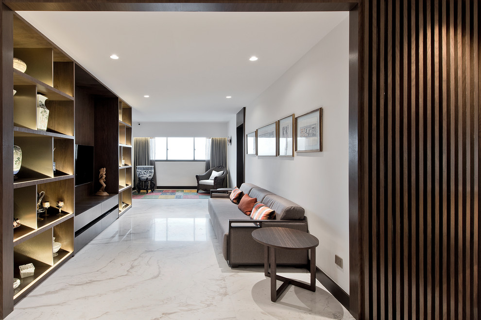 Asian formal open concept living room in Singapore with white walls, a built-in media wall and white floor.