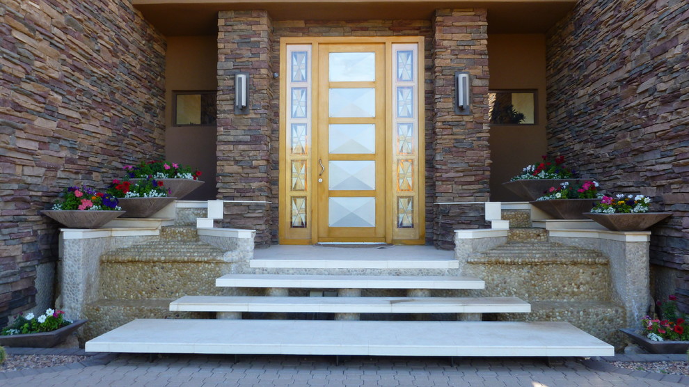 Front door - mid-sized rustic concrete floor and gray floor front door idea in Phoenix with brown walls and a light wood front door