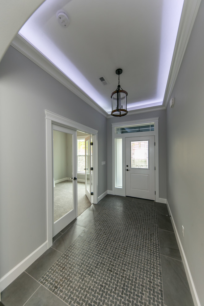 Front door - mid-sized transitional porcelain tile and gray floor front door idea in Seattle with gray walls and a white front door