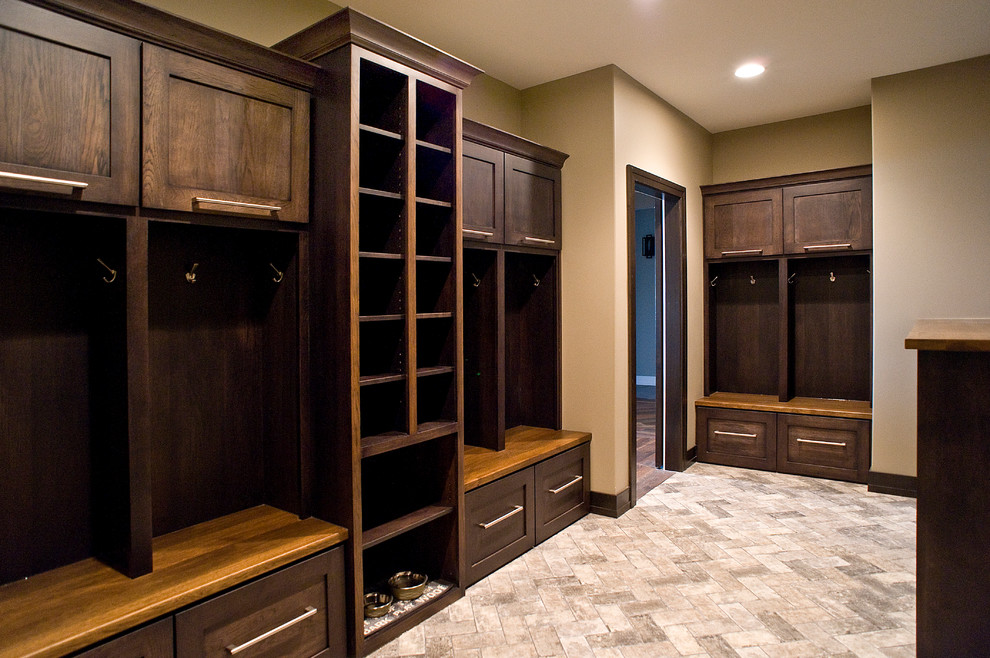 Inspiration for a large transitional brick floor mudroom remodel with beige walls