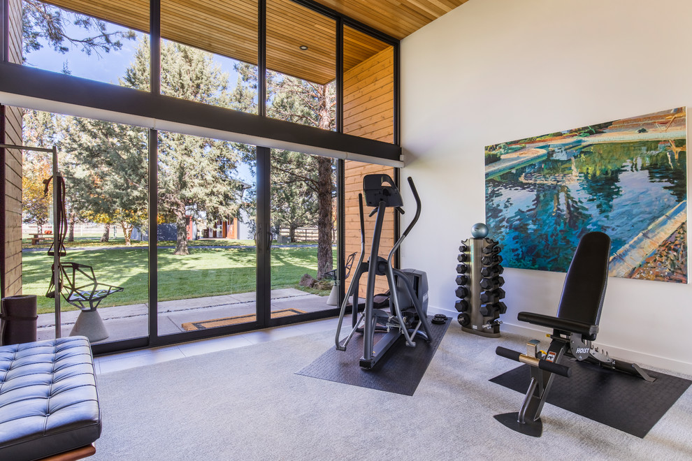 This is an example of a mid-sized contemporary multipurpose gym in Portland with white walls, carpet and grey floor.