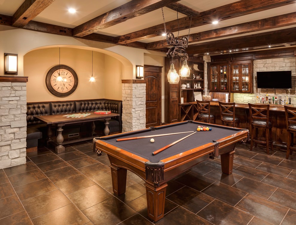 Large traditional walk-out basement in Chicago with beige walls, porcelain floors, a standard fireplace and brown floor.