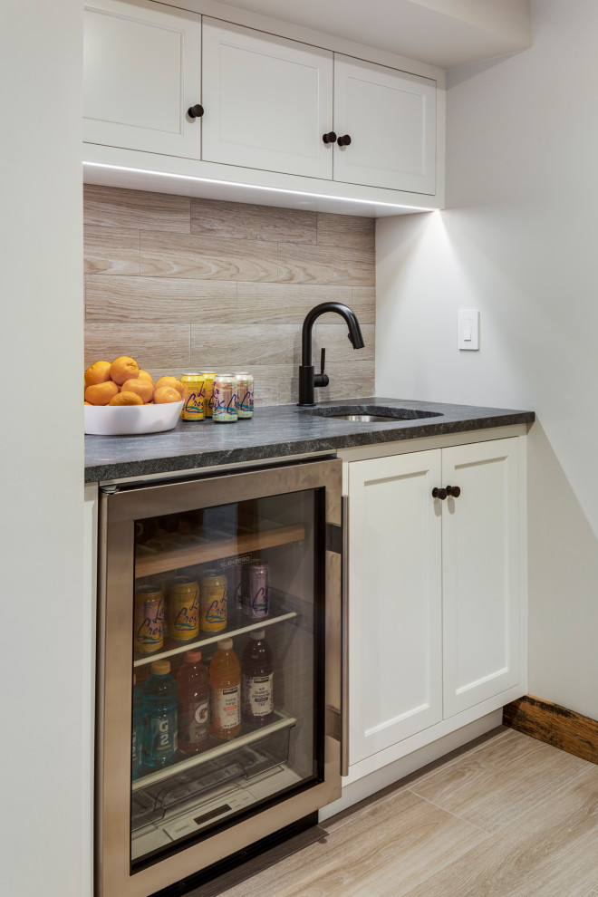 Example of a mid-sized transitional walk-out light wood floor basement design in Boston with white walls
