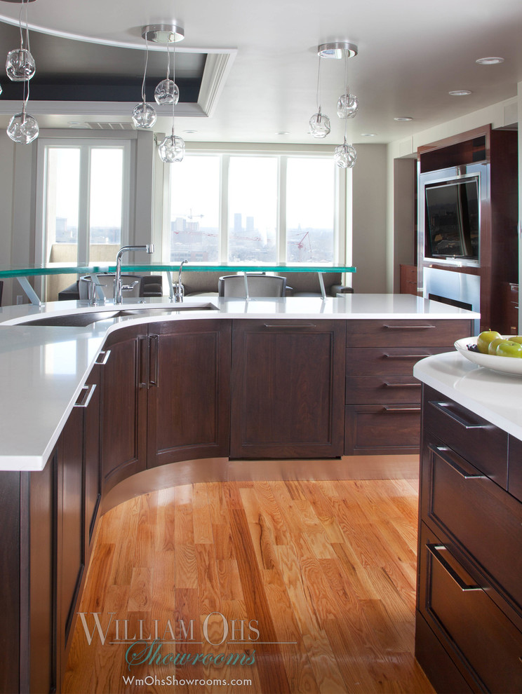 Eat-in kitchen - transitional l-shaped eat-in kitchen idea in Denver with a drop-in sink, beaded inset cabinets, brown cabinets, quartz countertops, glass sheet backsplash and stainless steel appliances