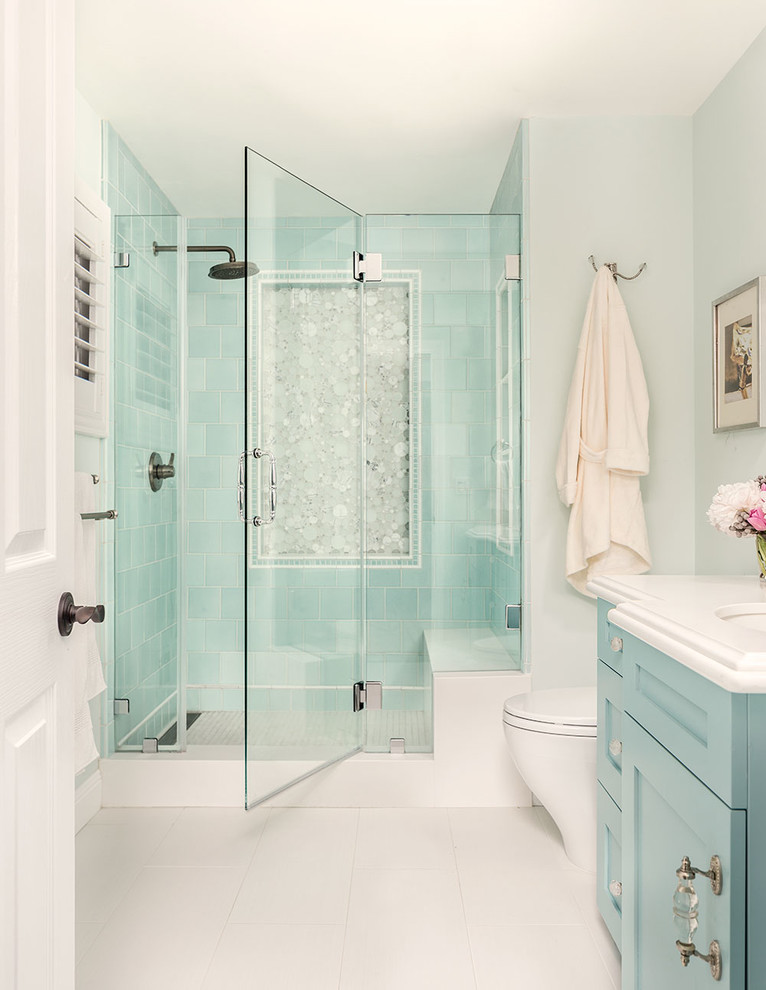 Mid-sized transitional 3/4 bathroom in San Francisco with shaker cabinets, blue cabinets, a one-piece toilet, blue tile, ceramic tile, blue walls, porcelain floors, engineered quartz benchtops, an undermount sink, an alcove shower, white floor and a hinged shower door.