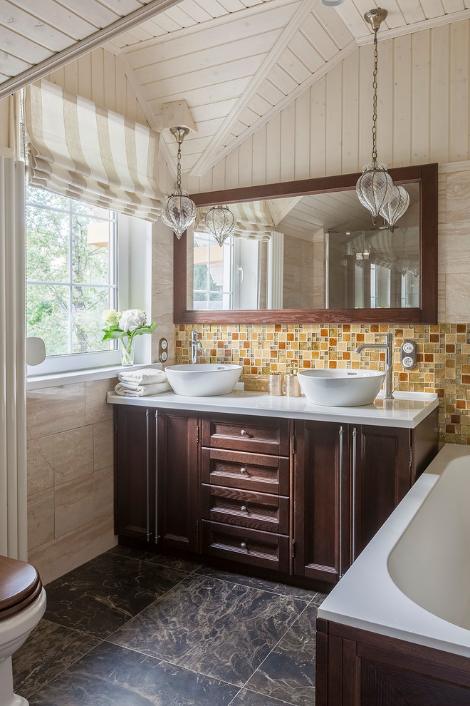Design ideas for a mid-sized transitional master bathroom in Moscow with recessed-panel cabinets, dark wood cabinets, a two-piece toilet, beige tile, yellow tile, orange tile, travertine, beige walls, ceramic floors, solid surface benchtops, brown floor, white benchtops, a vessel sink and a drop-in tub.