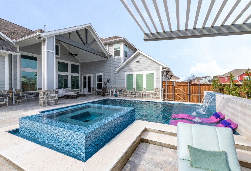 Mid-sized transitional backyard stone and custom-shaped pool photo in Dallas