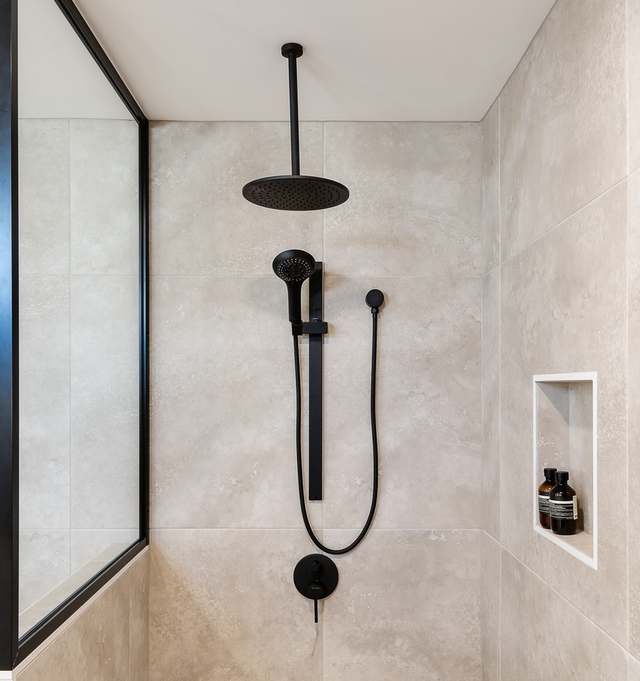 Inspiration for a large contemporary master bathroom in Brisbane with shaker cabinets, white cabinets, a drop-in tub, a double shower, a one-piece toilet, beige tile, porcelain tile, beige walls, porcelain floors, a console sink, solid surface benchtops, beige floor, an open shower and beige benchtops.