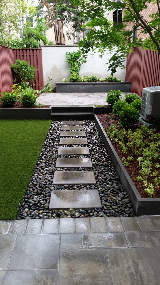 Small contemporary backyard garden in New York with a container garden and natural stone pavers.