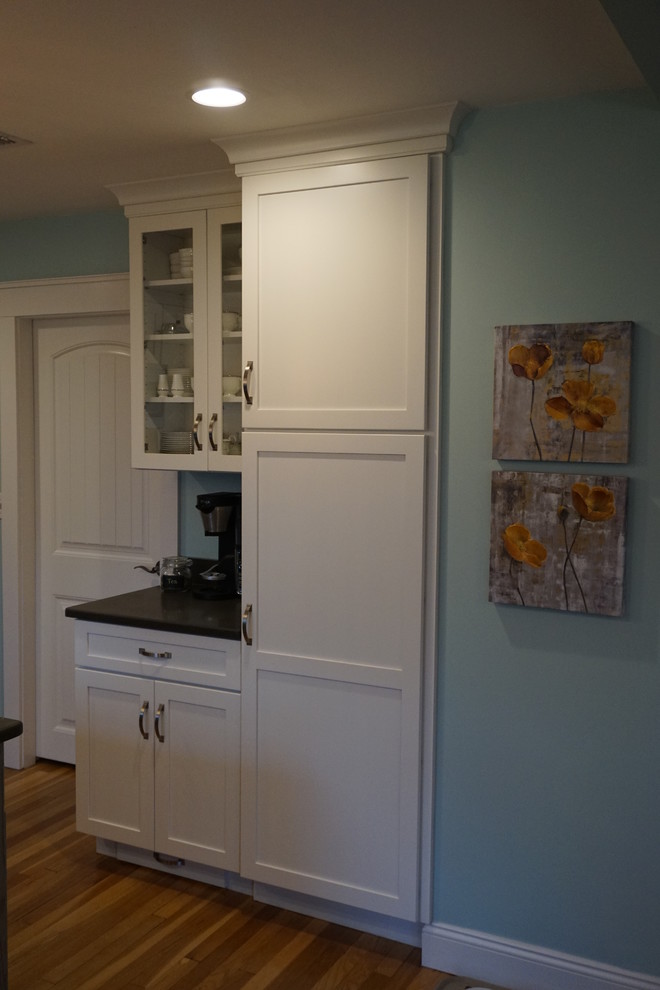 Inspiration for a mid-sized transitional u-shaped medium tone wood floor eat-in kitchen remodel in Boston with an undermount sink, shaker cabinets, gray cabinets, quartz countertops, black backsplash, stainless steel appliances and an island