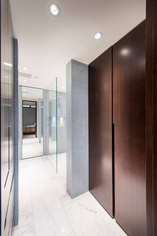 Inspiration for a mid-sized modern bathroom in Vancouver with a wall-mount sink, flat-panel cabinets, dark wood cabinets, an open shower, a wall-mount toilet, blue tile, ceramic tile, blue walls and marble floors.