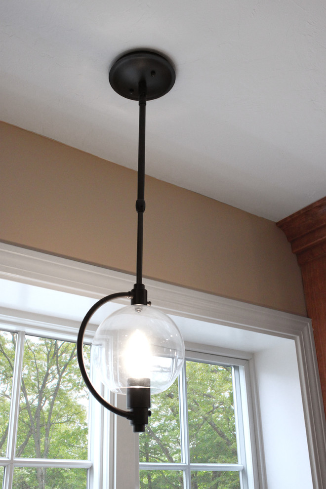 Inspiration for a large transitional u-shaped light wood floor home design remodel in Boston with an undermount sink, shaker cabinets, medium tone wood cabinets, quartz countertops, gray backsplash, porcelain backsplash, stainless steel appliances and a peninsula