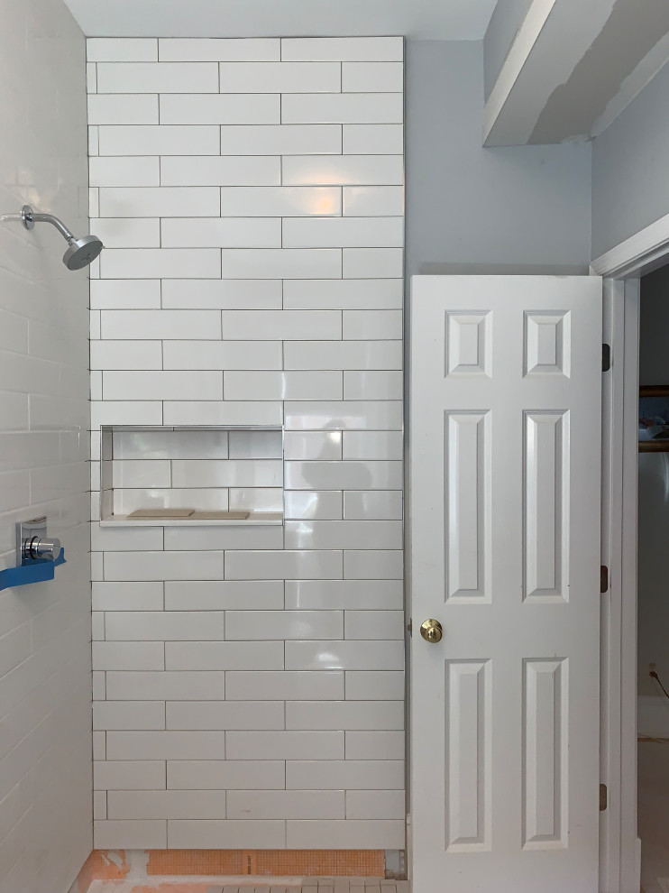 Photo of a small modern master bathroom in DC Metro with flat-panel cabinets, grey cabinets, a curbless shower, a two-piece toilet, white tile, subway tile, white walls, porcelain floors, an undermount sink, quartzite benchtops, grey floor, a hinged shower door, white benchtops, a single vanity and a floating vanity.
