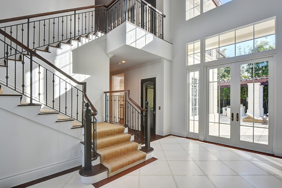 Large mediterranean foyer in Miami with white walls, porcelain floors, a double front door and a white front door.