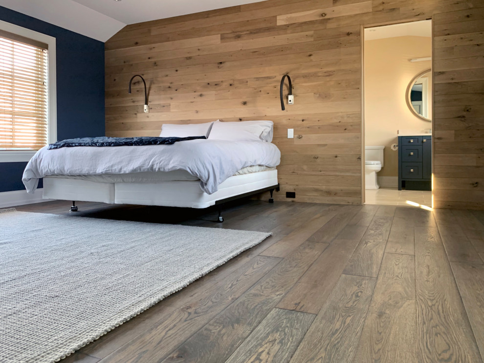 Photo of a contemporary guest bedroom in Chicago with brown walls, medium hardwood floors, brown floor and planked wall panelling.