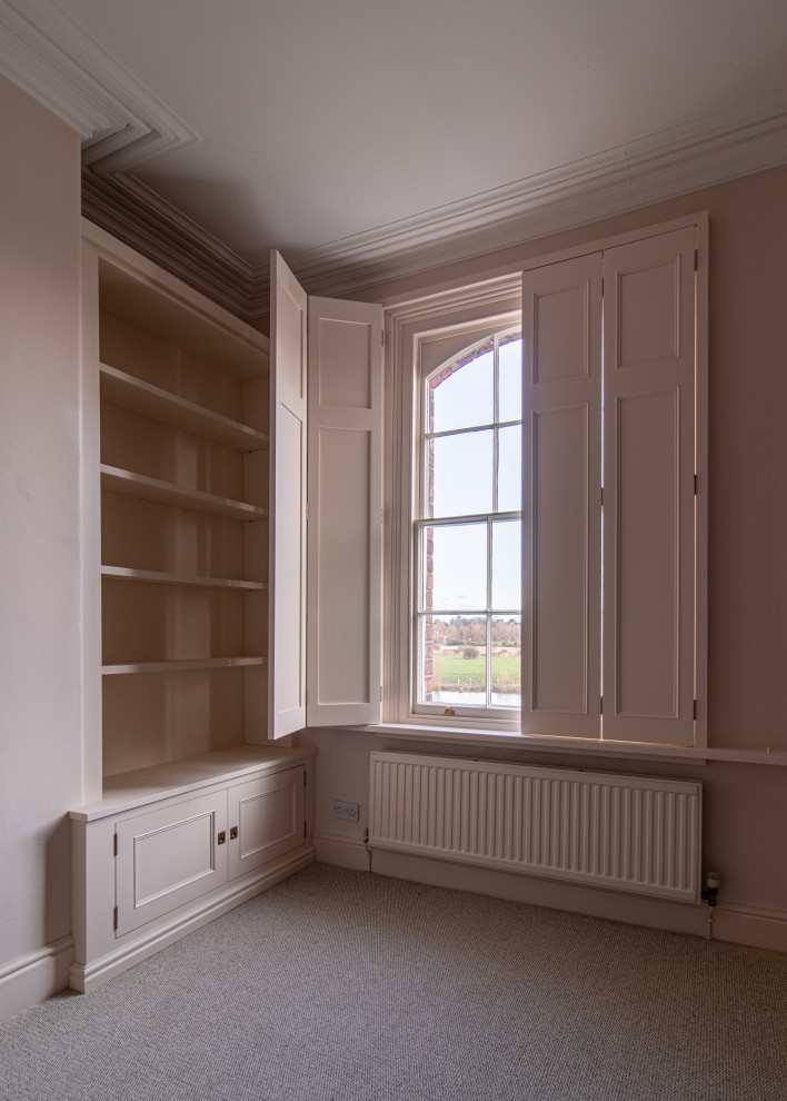 Design ideas for a mid-sized traditional home office in Cheshire with beige walls, carpet and beige floor.