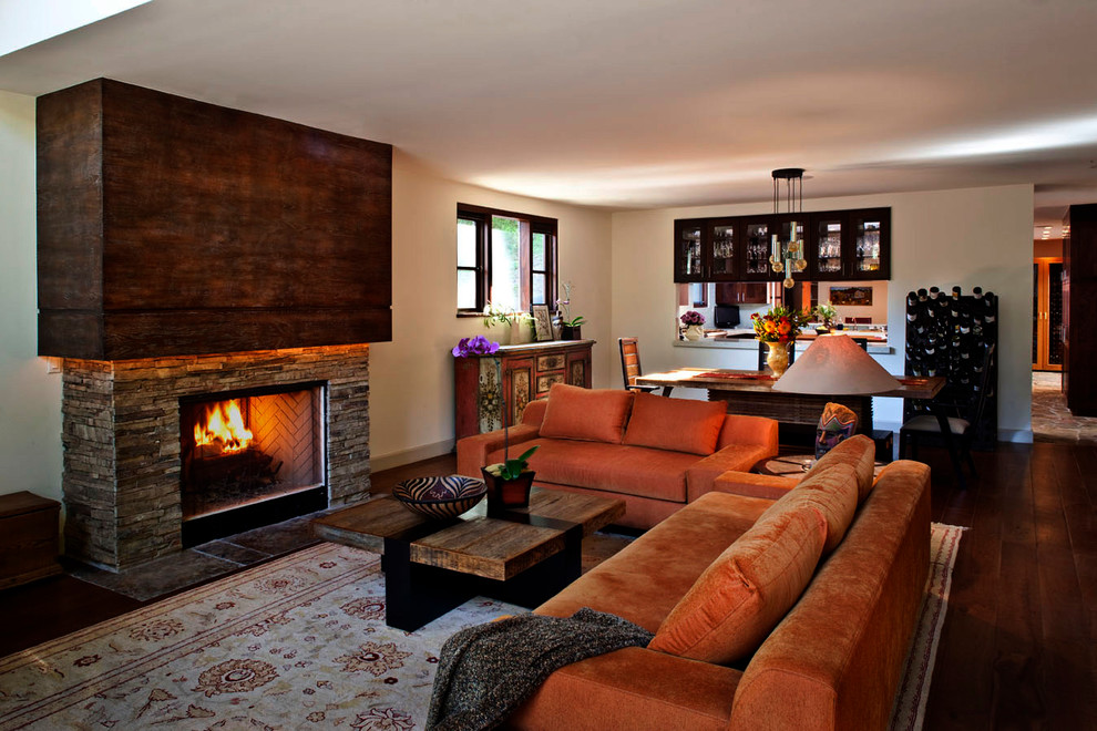 This is an example of a contemporary living room in Los Angeles with a metal fireplace surround.