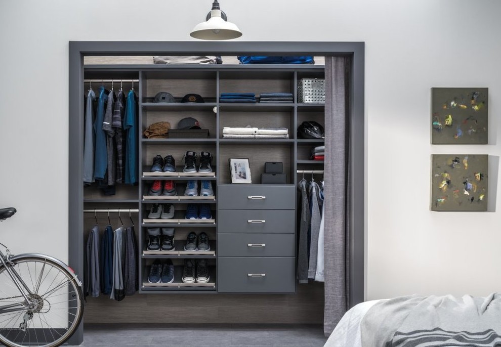 Design ideas for a small transitional gender-neutral built-in wardrobe in Other with grey cabinets and carpet.